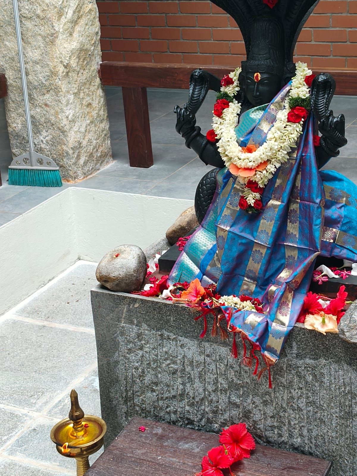 Bala Naga Kanni murti draped in a blue silk offering with jasmine and hibiscus